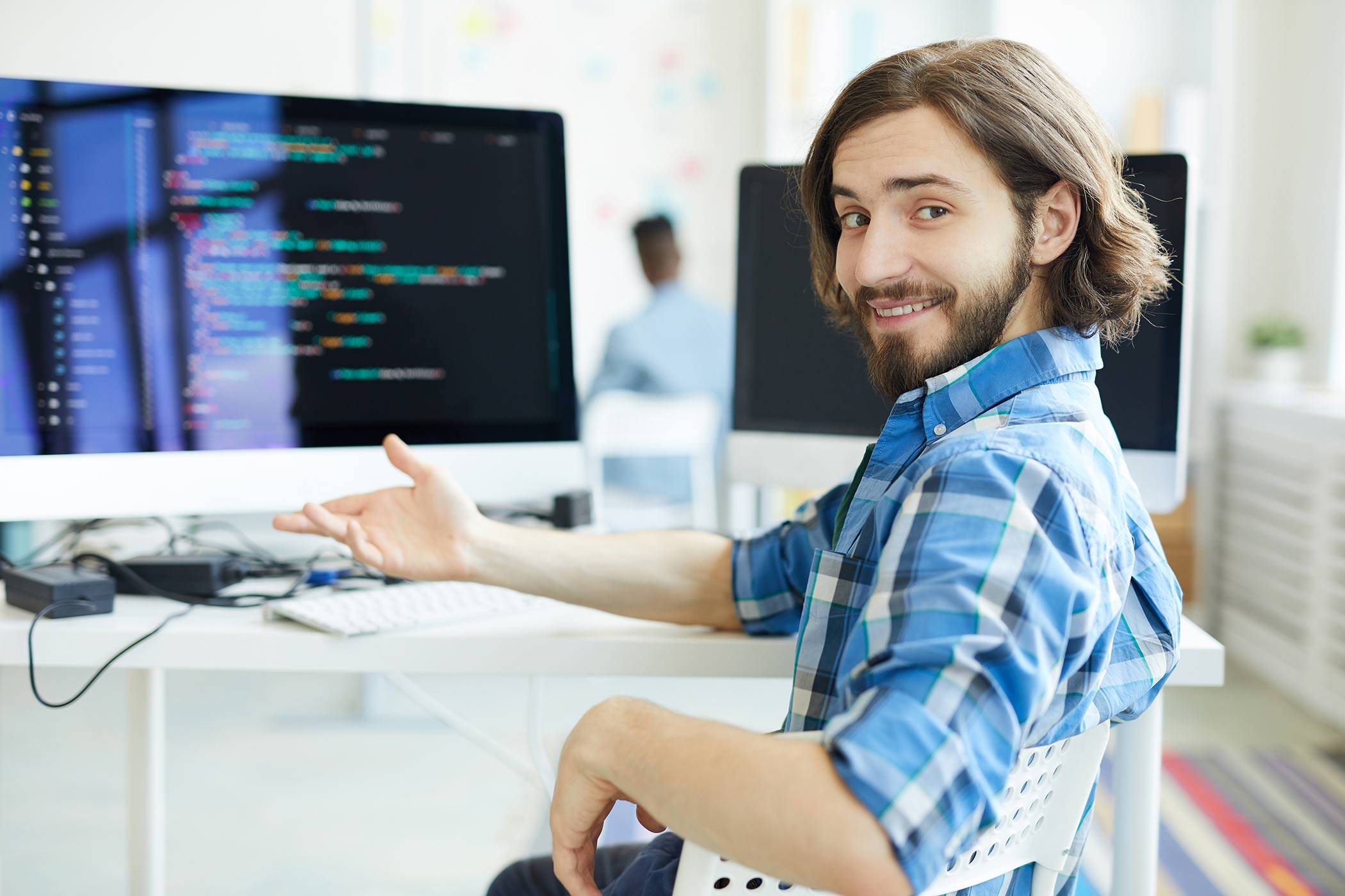 developer smiling and showing his code to the camera