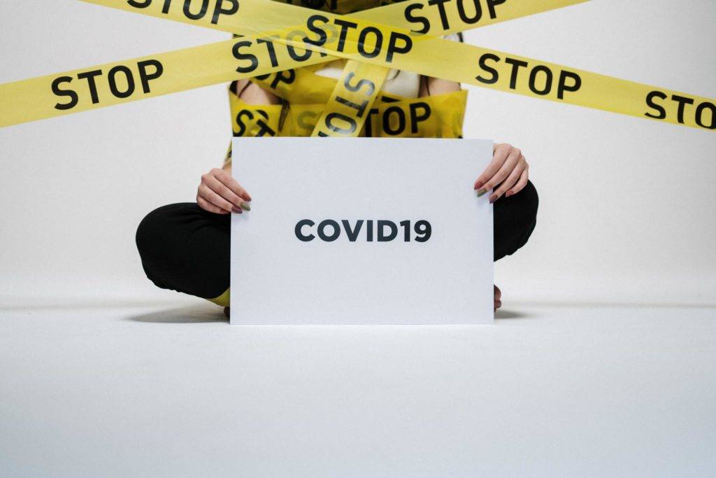 Covid 19 sign with caution tape