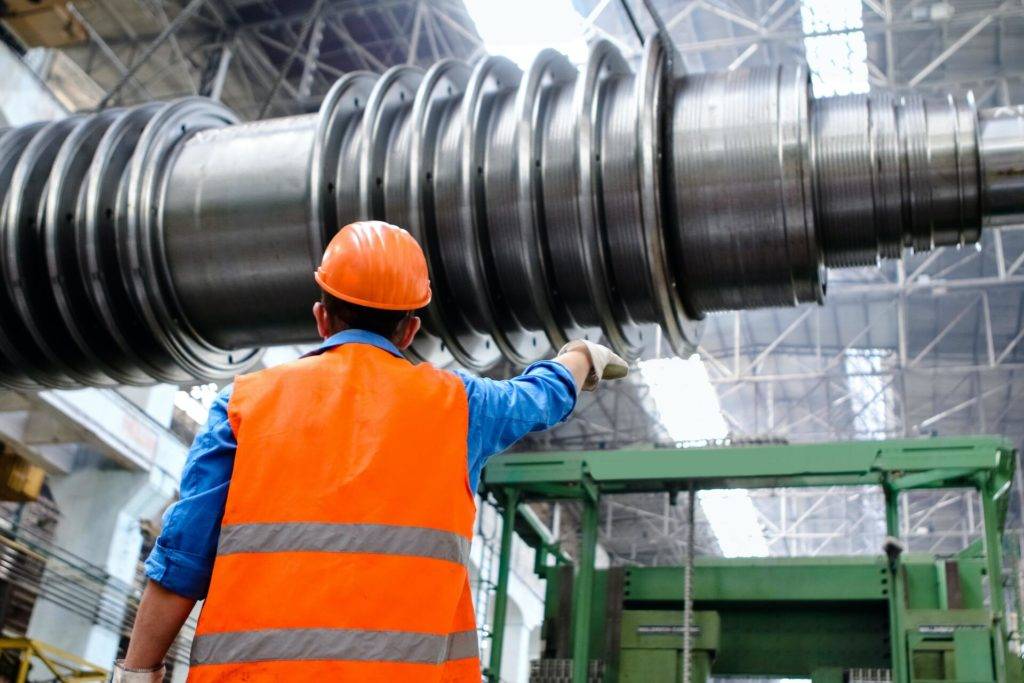 construcion worker pointing something out in a factory
