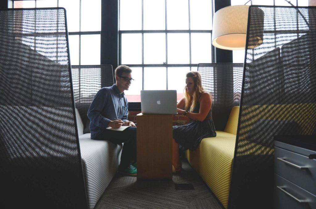 two professionals meeting looking at a laptop