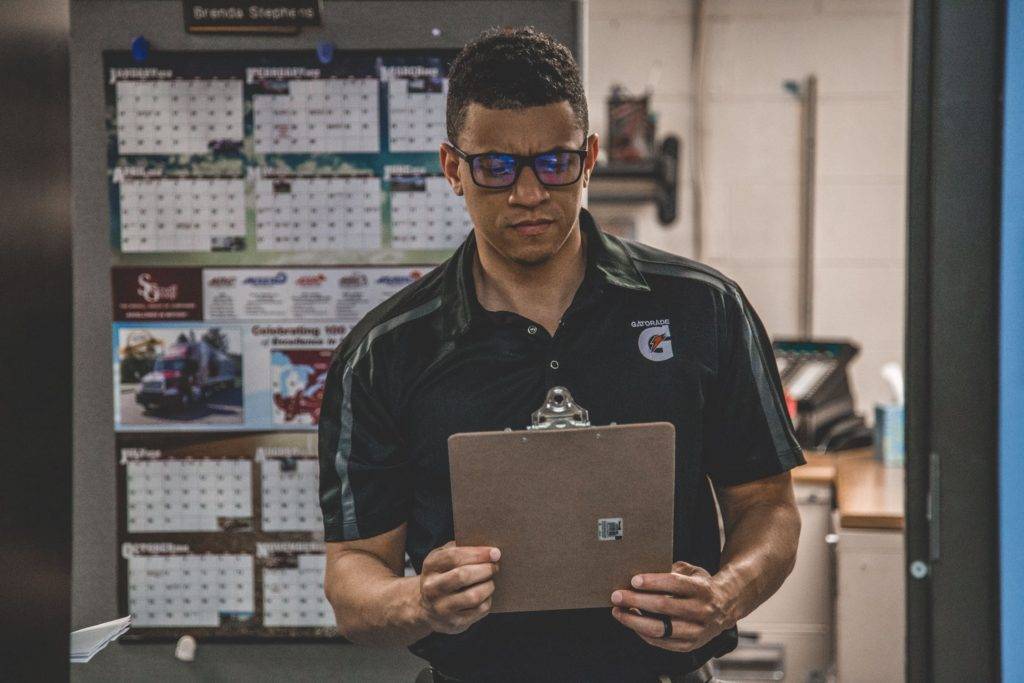 warehouse manager looking at clipboard