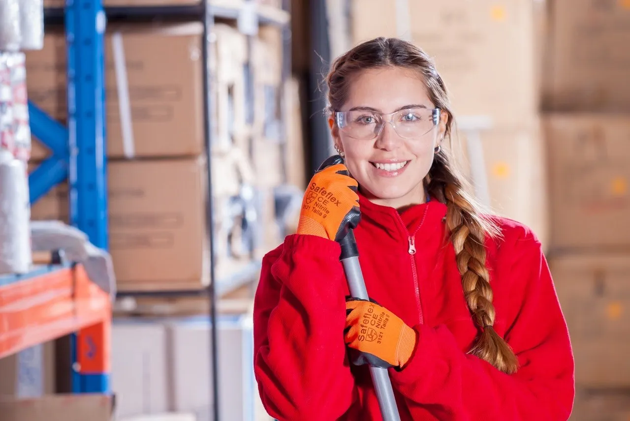 woman smiling while working in a warehouse
